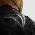 Närbild på baksidan av Rebelhorn Dam Textil Mc-Jacka Jax med rosa accenter och ventilationspaneler. Ergonomisk och säker design.