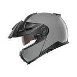 Schuberth E2 grå mc-hjälm med stilren design och integrerat visir, sedd från sidan. Passar både dam och herr för stad och touring.